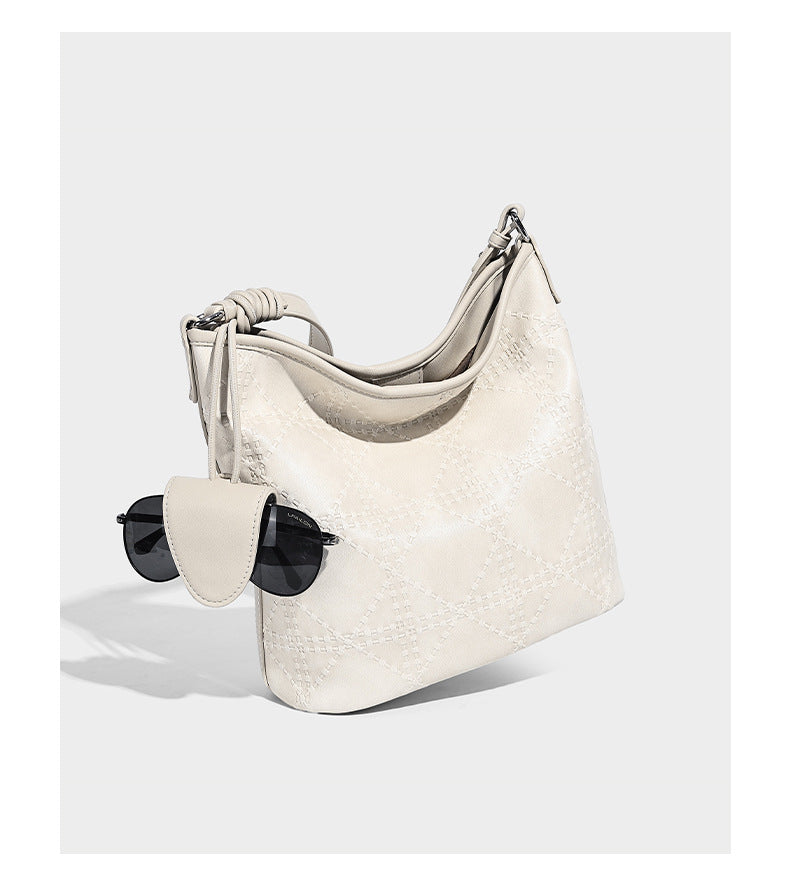 Diamond-quilted leather-look bucket shoulder bag with knotted strap accent and attached mini pouch, detail view 10