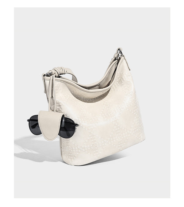 Diamond-quilted leather-look bucket shoulder bag with knotted strap accent and attached mini pouch, detail view 10