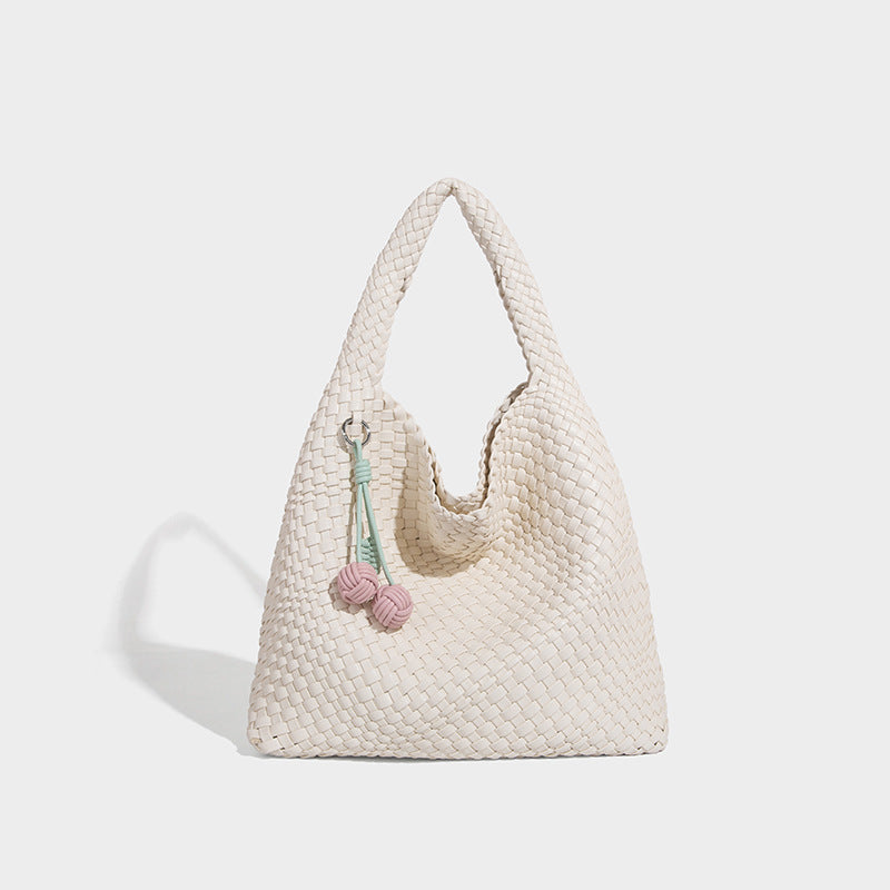 Soft hand-woven slouchy hobo tote bag with knotted tassel charm and single looped shoulder strap, detail view 7