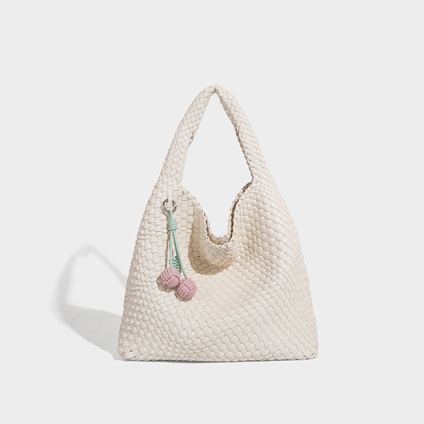 Soft hand-woven slouchy hobo tote bag with knotted tassel charm and single looped shoulder strap, detail view 7