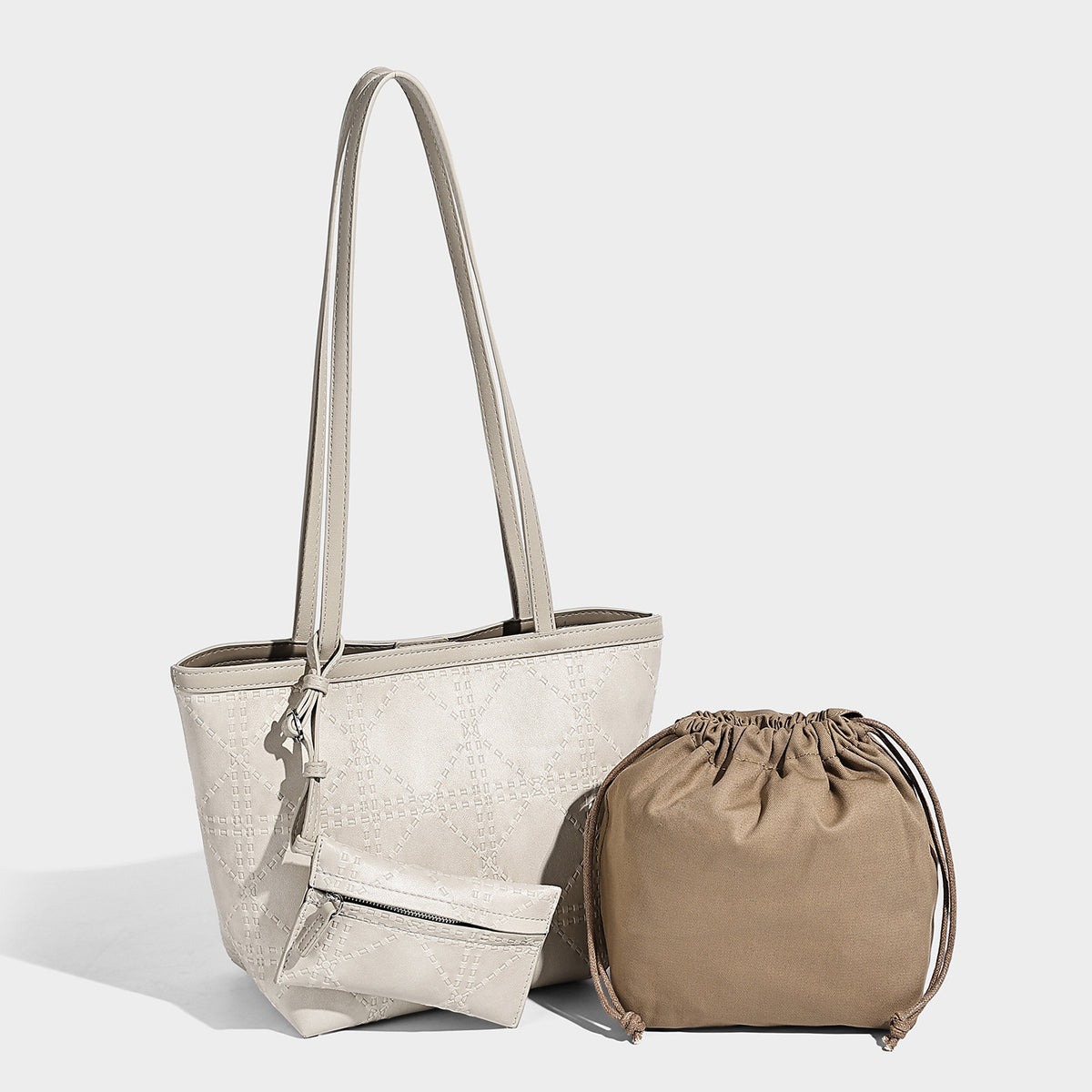 Quilted diamond-pattern tote bag with attached front zip pouch and long shoulder straps, front view