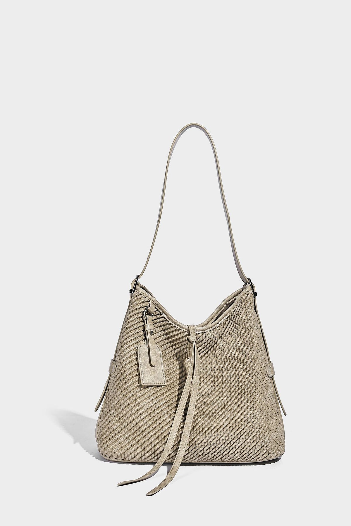 Große Schultertasche im Beuteltaschenstil mit Flechtstruktur, glatten Besätzen in Lederoptik, verstellbarem Riemen und Anhänger-Detail, Detailansicht