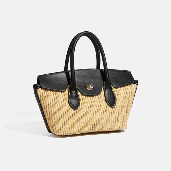 Structured tan woven straw tote bag with black leather-look trim, twin rounded top handles, gold-tone turn-lock front flap