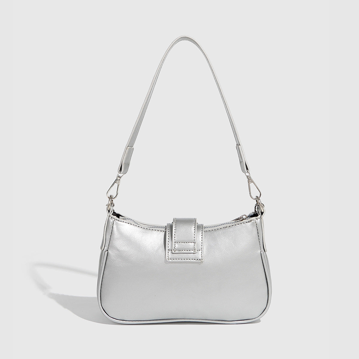 Compact metallic silver shoulder bag with glitter star appliqués, rhinestone star charms, front belt buckle strap, chunky