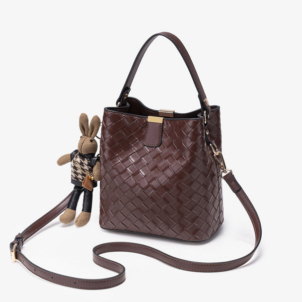 Brown woven-emboss leather-look bucket bag with short top handle, detachable crossbody strap, gold-tone hardware, and rabbit