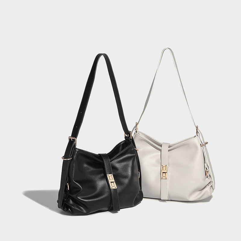 Soft slouchy hobo shoulder bag with smooth leather-look finish, gold-tone buckle and tab hardware, and long adjustable strap