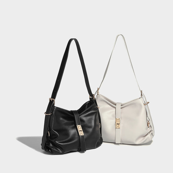 Soft slouchy hobo shoulder bag with smooth leather-look finish, gold-tone buckle and tab hardware, and long adjustable strap