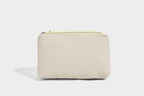 Structured trapezoid tote bag in pebbled leather-look finish with double top handles, silver-tone bar hardware, and, detail