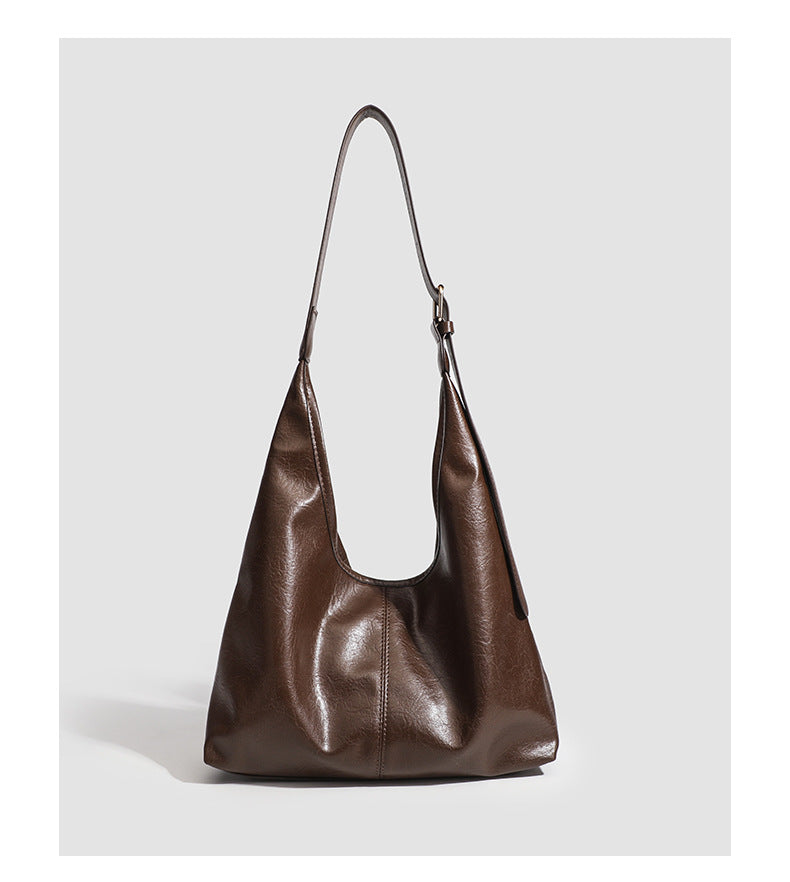 Large slouchy hobo shoulder bag in smooth leather-look finish with adjustable strap and gold-tone hardware, detail view 15