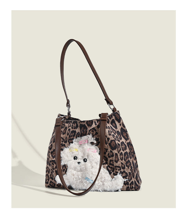 Leopard-print fabric tote bag with white plush teddy bear appliqué and brown leather-look shoulder straps, detail view 10