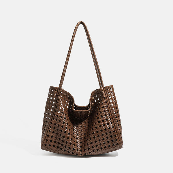 Slouchy open-lattice woven shoulder tote bag with long braided straps and matching zip pouch, front view