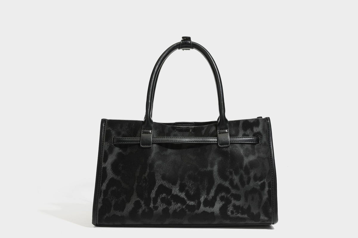 Structured leopard-print tote bag with glossy satin-like finish, dual rounded top handles, silver buckle-and-ring front