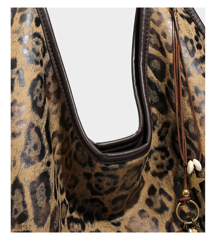 Large slouchy leopard-print shoulder tote bag with glossy tan-and-brown finish, dark brown leather-look trim, single