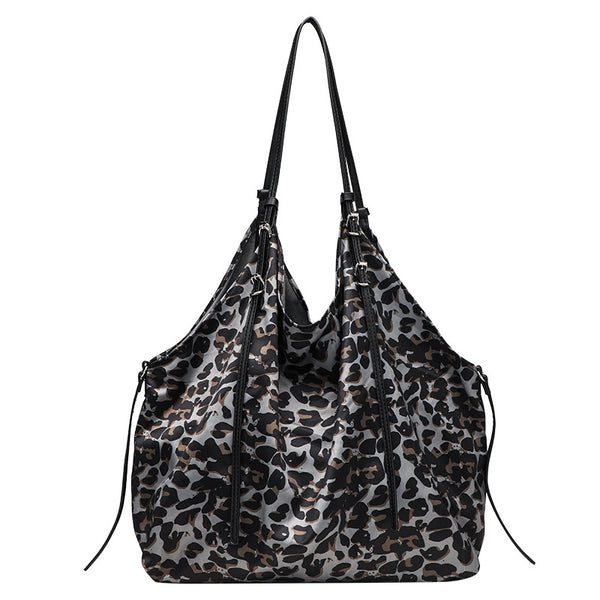 Large leopard-print slouchy tote shoulder bag in grey, black, and tan with gold-tone hardware and adjustable leather-look