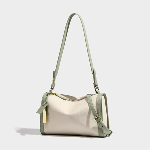 Structured two-tone shoulder bag with pebbled leather-look finish, contrast trim, top zip closure, and gold-tone hardware