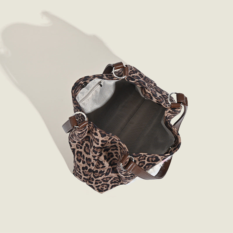 Leopard-print fabric tote bag with white plush teddy bear appliqué and brown leather-look shoulder straps, detail view 4