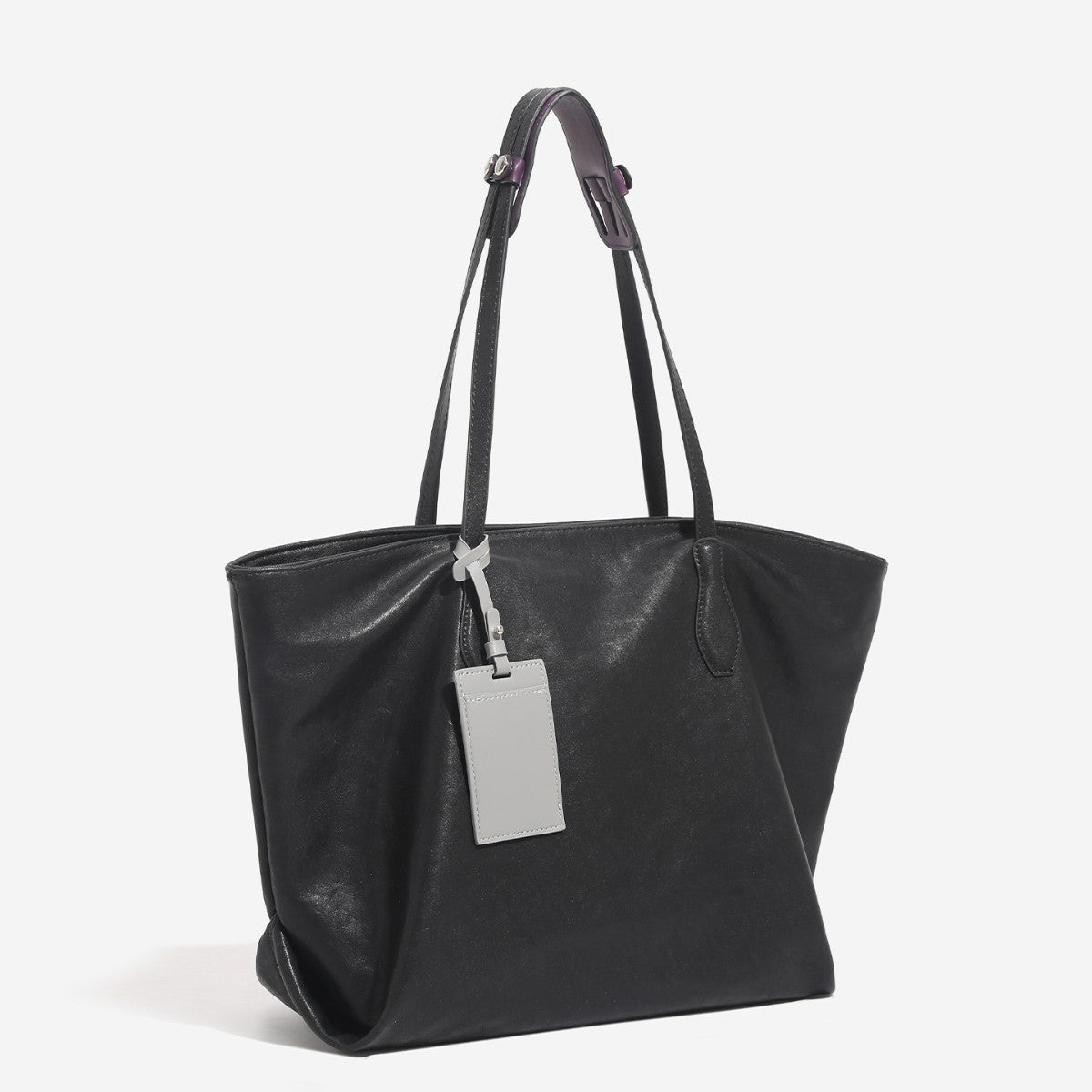 Large leather-look tote bag with trapezoid silhouette, double shoulder straps, and detachable hanging tag, detail view 2