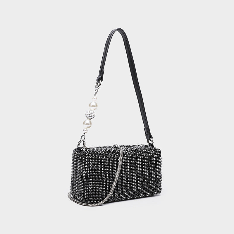 Small rectangular all-over rhinestone crossbody bag with pearl bead zipper pull and detachable silver chain strap, detail