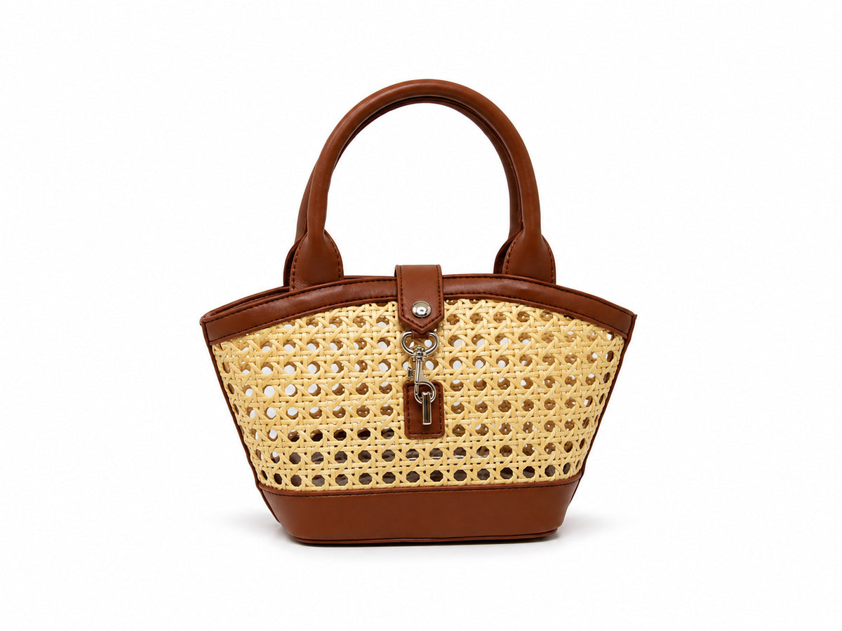 Structured mini tote bag with open-weave rattan body, leather-look arched handles and trim, front tab turn-lock closure, and