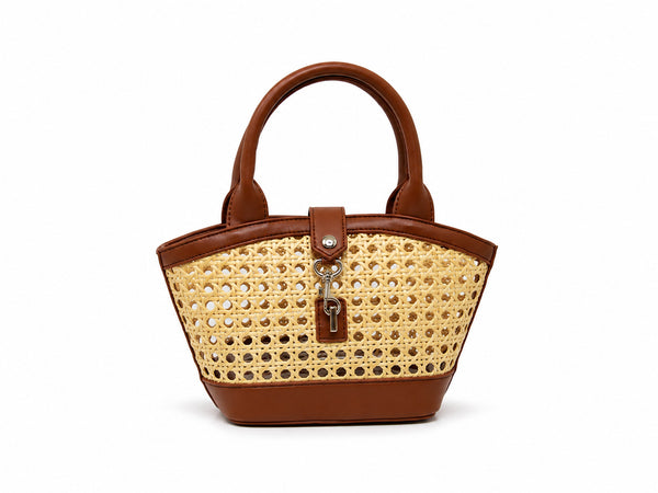 Structured mini tote bag with open-weave rattan body, leather-look arched handles and trim, front tab turn-lock closure, and