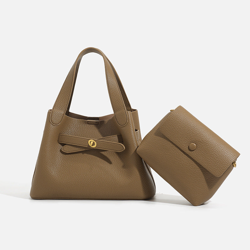 Pebbled trapezoid tote bag with gold turn-lock strap detail and matching snap pouch, detail view 3