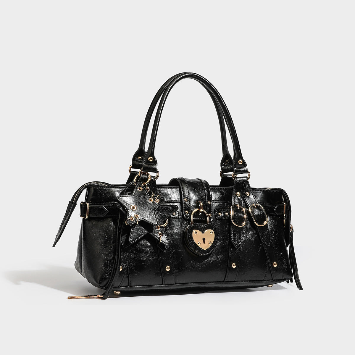Glossy dark brown structured Boston satchel with heart-shaped lock charm, star pendant, rivet studs, multi-strap front panel