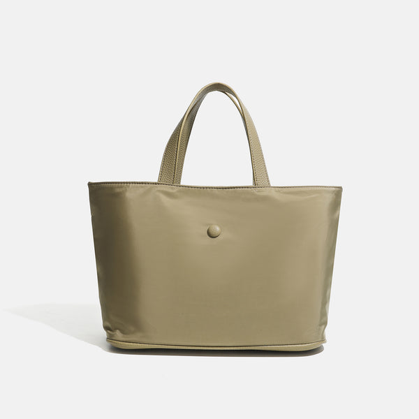 Structured lightweight nylon tote bag with textured double top handles and snap-button front detail, detail view 10