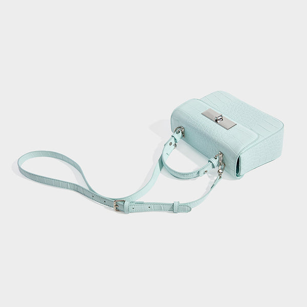 Small structured rectangular satchel with glossy crocodile-embossed finish, arched top handle, front flap, and silver-tone