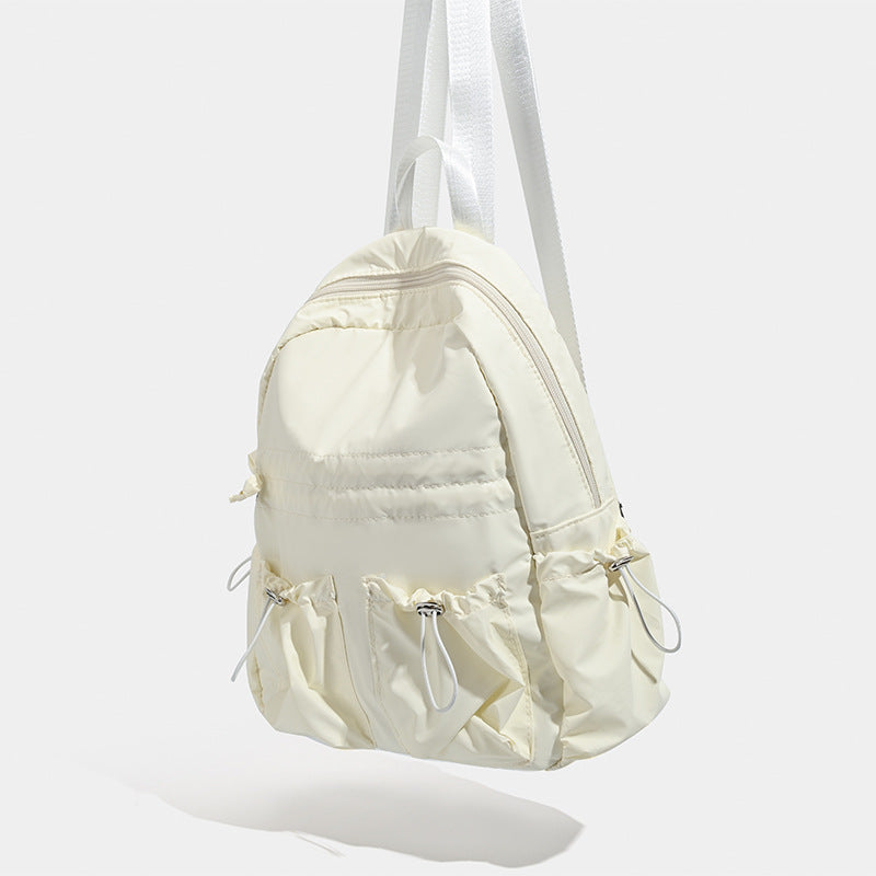 Puffy matte nylon mini backpack with drawcord gathered front pockets and silver-tone hardware, detail view 3