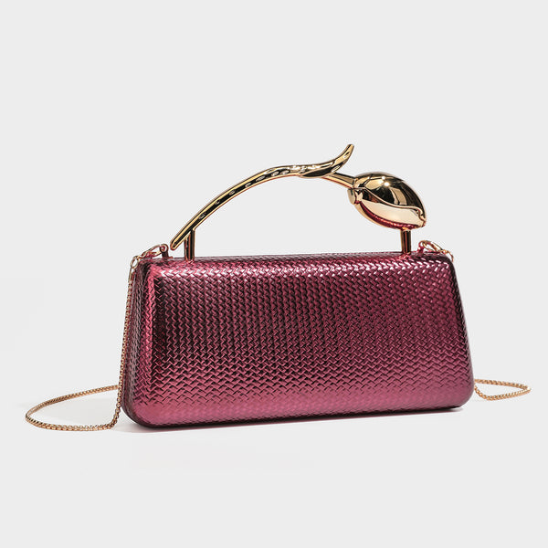 Structured rectangular metallic woven clutch bag with sculptural gold-tone leaf top handle and detachable chain strap, detail