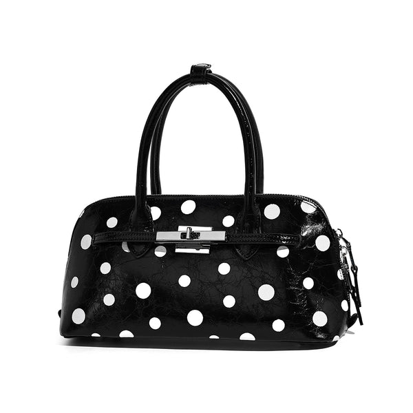 Structured polka-dot Boston bag with glossy crinkled finish, dual top handles, silver-tone turn-lock clasp, and detachable