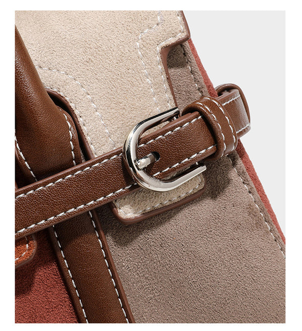 Structured color-block satchel bag in brown, rust, beige, and taupe suede-look panels with white topstitching, front buckle