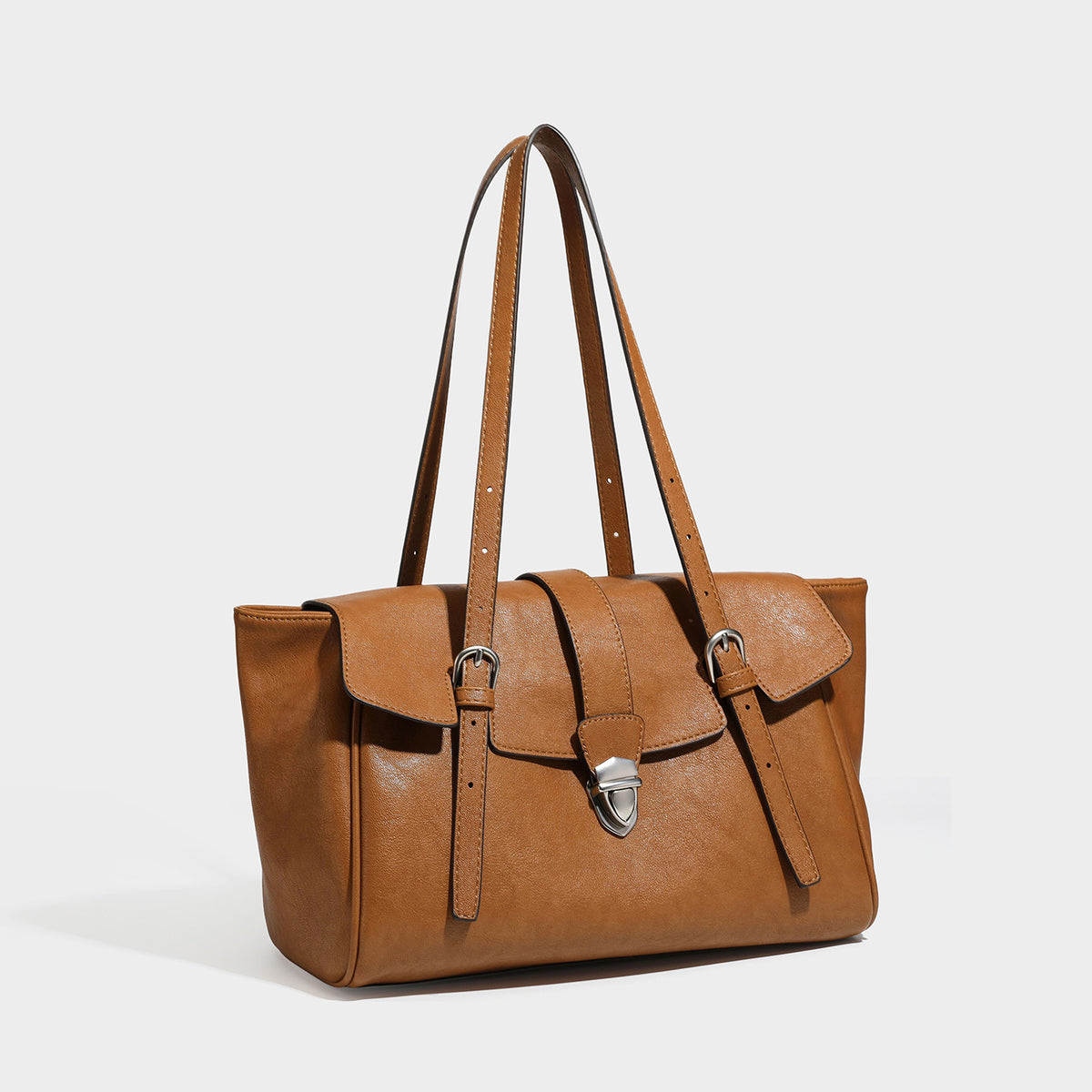 Large structured vintage-style tote bag with flap-front turn-lock closure, twin buckle straps, and double shoulder handles