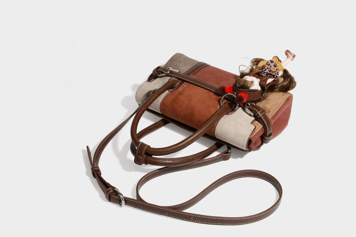 Structured color-block satchel bag in brown, rust, beige, and taupe suede-look panels with white topstitching, front buckle