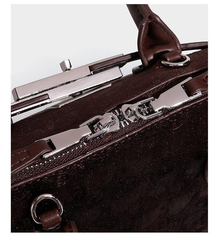 Small structured satchel bag in dark brown velvet-like textured finish with leather-look trim, silver-tone turn-lock bar