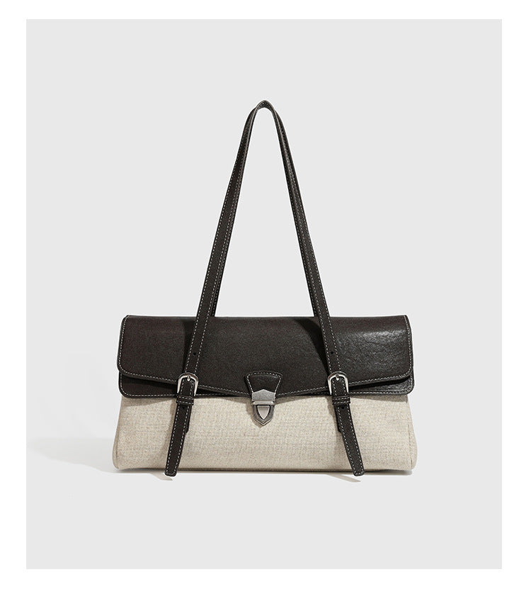 Strukturierte zweifarbige Schultertasche mit schwarzer Klappe in Lederoptik, cremefarbenem Korpus mit Webstruktur, silberfarbenem Drehverschluss und doppeltem