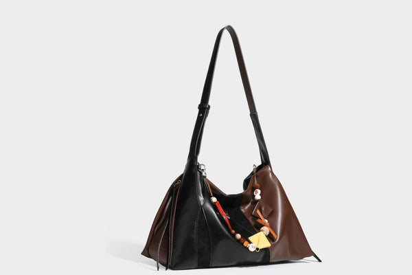 Two-tone black and brown leather-look slouchy shoulder bag with beaded tassel charm and silver-tone hardware, detail view 23