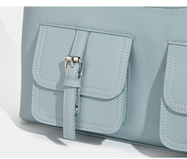 Powder blue structured tote bag with dual front flap buckle pockets and silver-tone hardware, detail view 8
