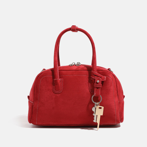 Compact retro Boston satchel bag with matte suede-look finish, twin rounded top handles, double zip closure with silver-tone