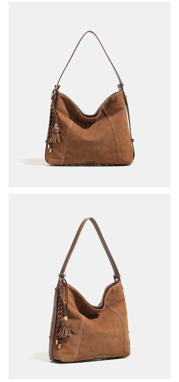 Slouchy suede-finish hobo shoulder bag in warm mocha brown with contrast stitching, braided tassel side accent, and, detail