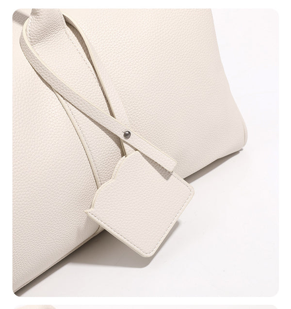 Large cream white pebbled leather-look barrel travel bag with twin top handles, chunky chain shoulder strap, front zip