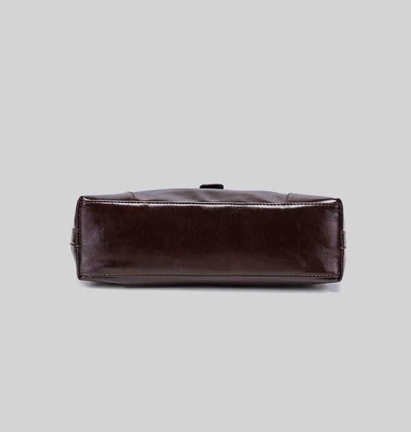 Glossy dark brown slouch hobo shoulder bag with front buckle strap panel and long adjustable single strap, detail view 16