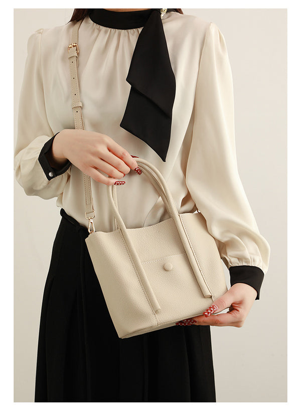 Structured pebbled matte tote bag with front snap pocket, dual top handles, and detachable zip pouch in almond beige, detail