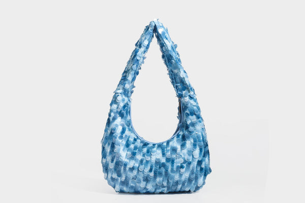 Slouchy crescent hobo shoulder bag covered in overlapping reflective sequin discs with a single integrated strap and top-zip
