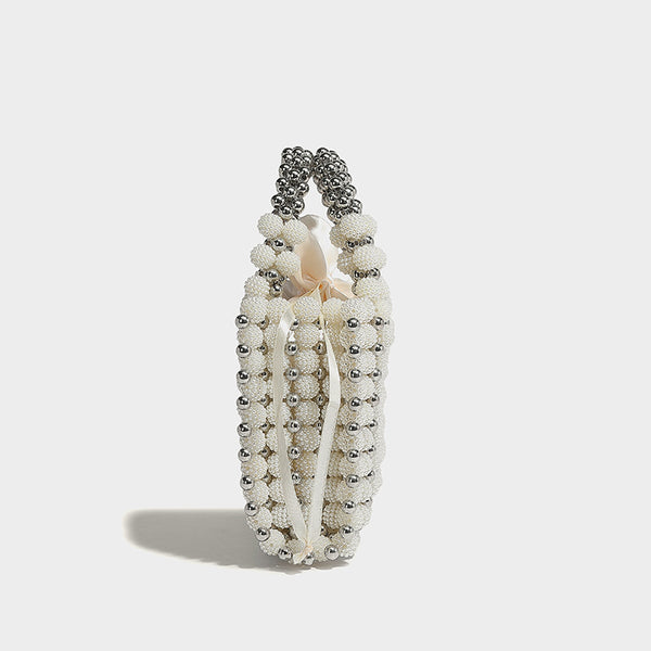 Small boxy pearl-bead mini top-handle bag with silver metallic bead accents, satin floral detail, and long beaded shoulder
