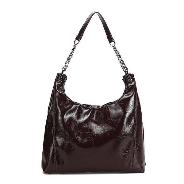 Glossy crinkled leather-look slouchy hobo bag with silver chain-and-leather shoulder strap and open top, detail view 5