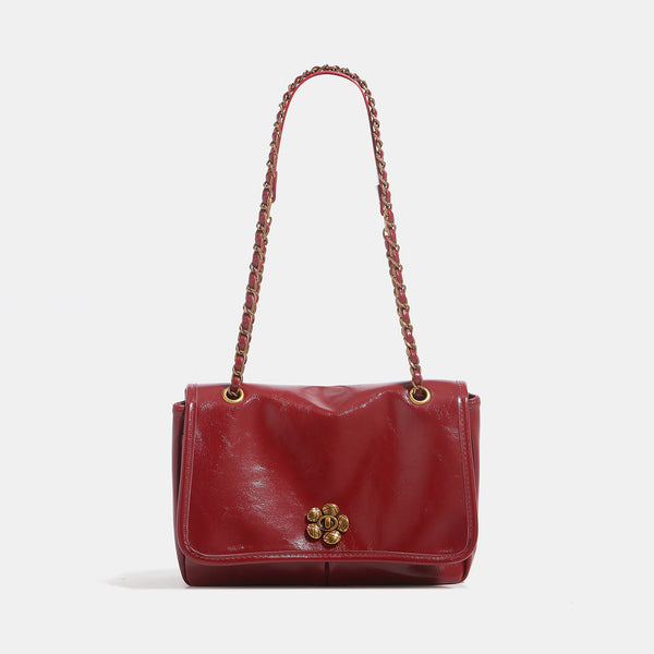 Structured glossy flap shoulder bag with antique gold floral turn-lock clasp and chain-and-leather strap, detail view 9