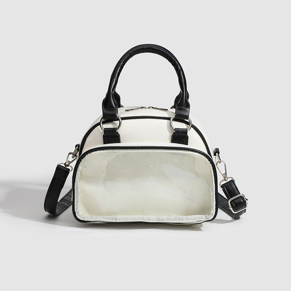 Structured mini bowling barrel bag with clear front pocket, dual top handles, and detachable crossbody strap in glossy, front
