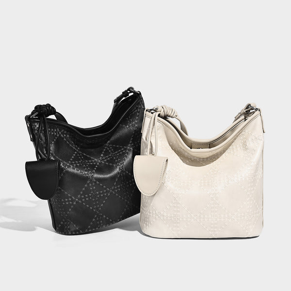 Diamond-quilted leather-look bucket shoulder bag with knotted strap accent and attached mini pouch, detail view 2