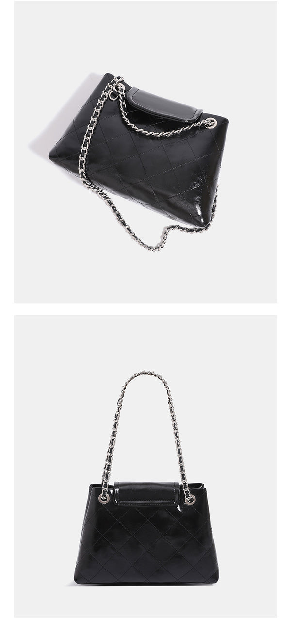 Quilted trapezoid shoulder bag with chain straps, flap closure, and ring hardware, detail view 13